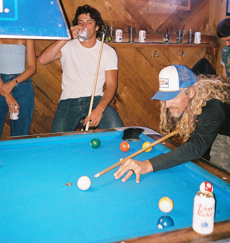 People playing pool and drinking beer